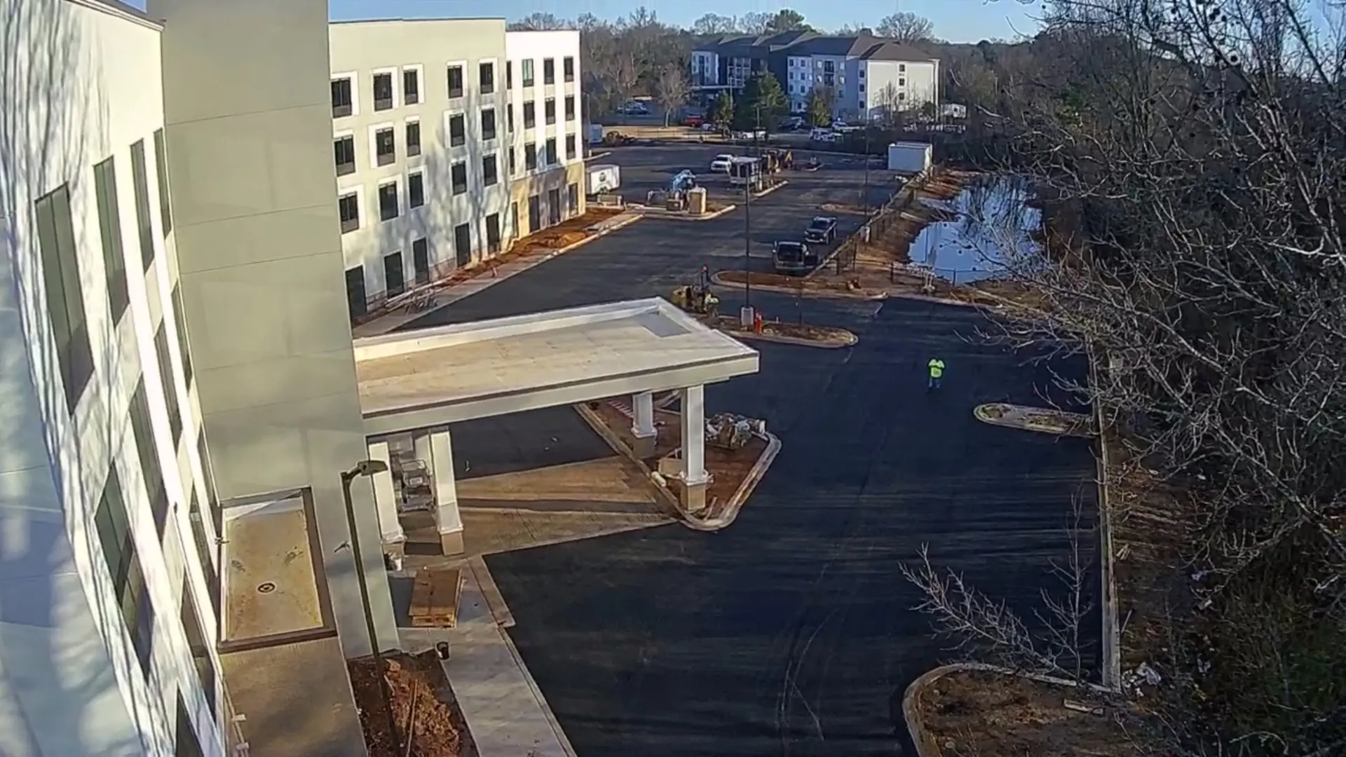 Aerial of an apartment complex with a paved parking area in North Alabama