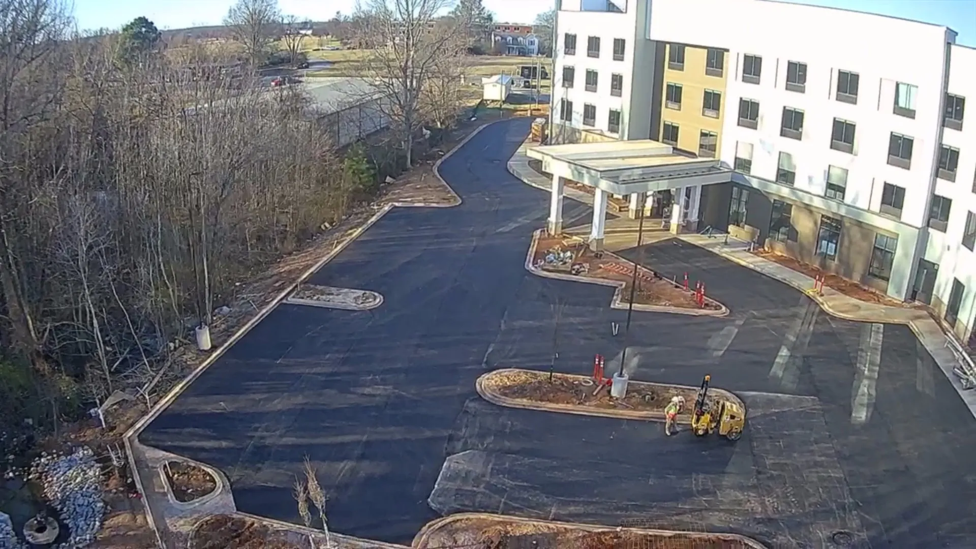 Aerial of apartment complex with paved drives and pool