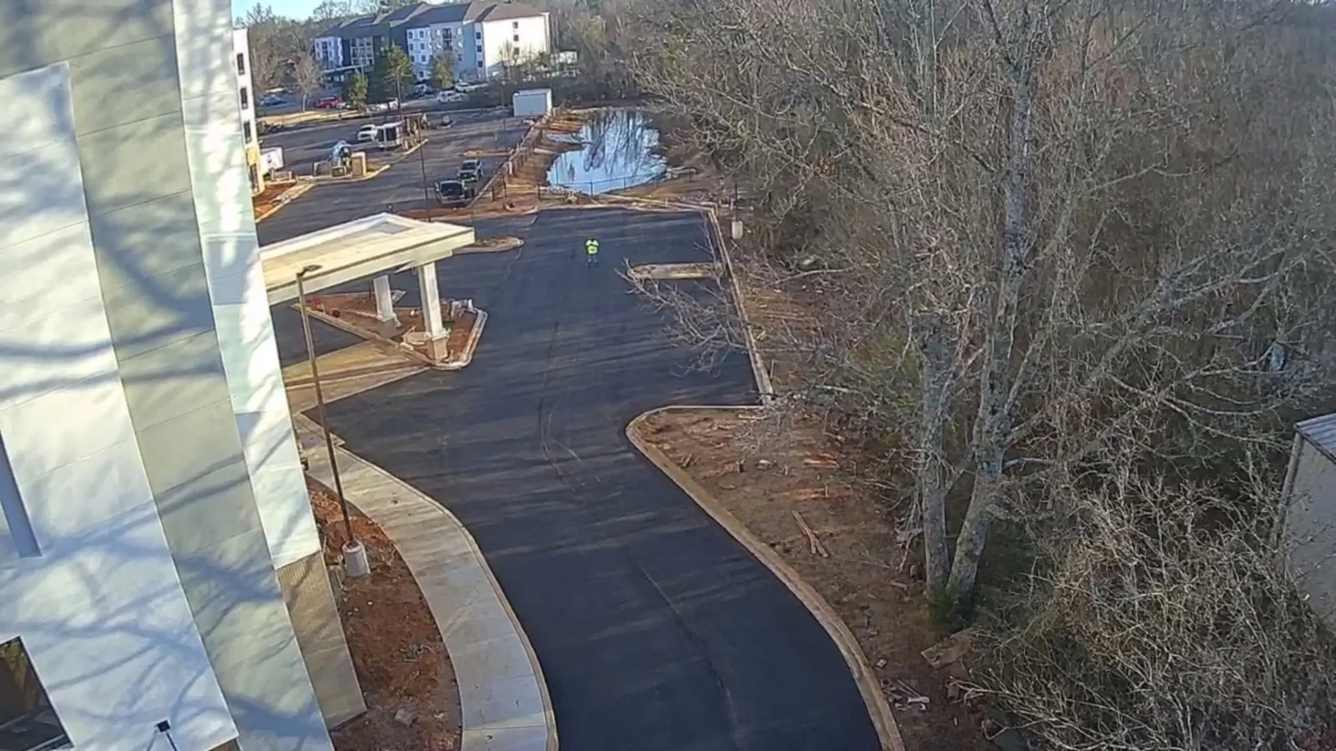 Aerial view of fresh asphalt drive at a hotel after sealcoating