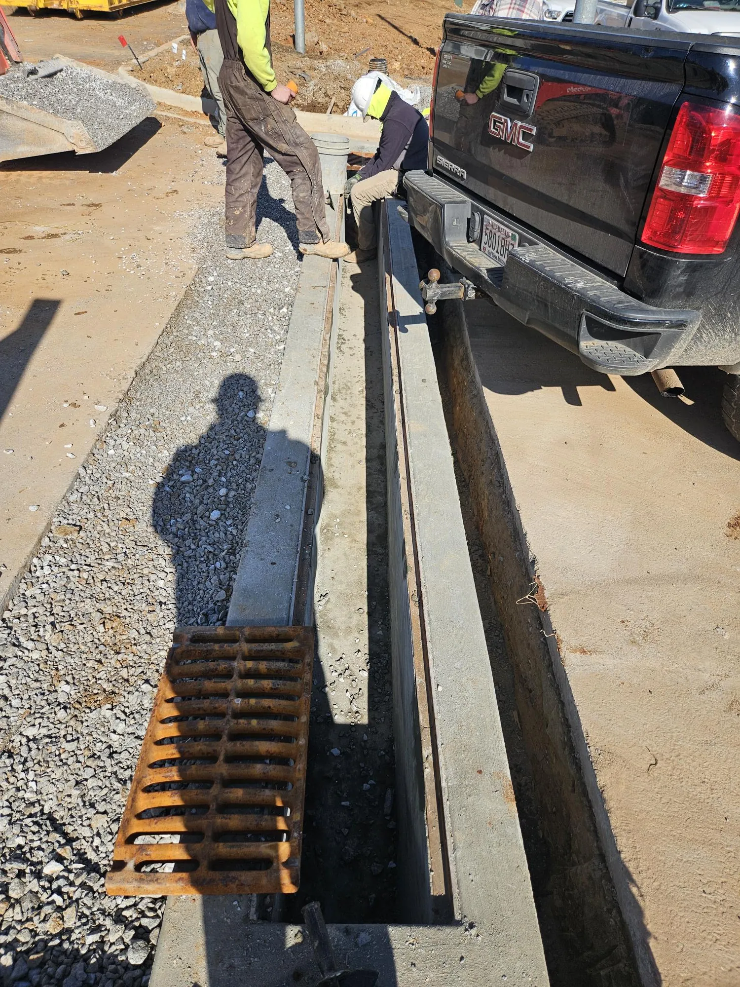 Asphalt being delivered from a truck during a paving job