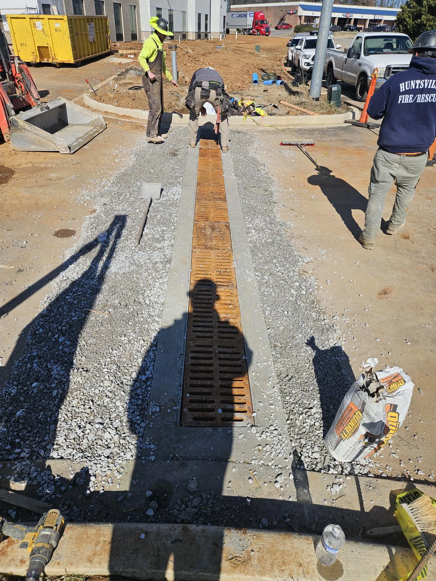 Paving crew preparing the gravel base before laying asphalt