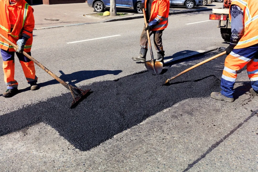 Pothole patching repair on an asphalt driveway