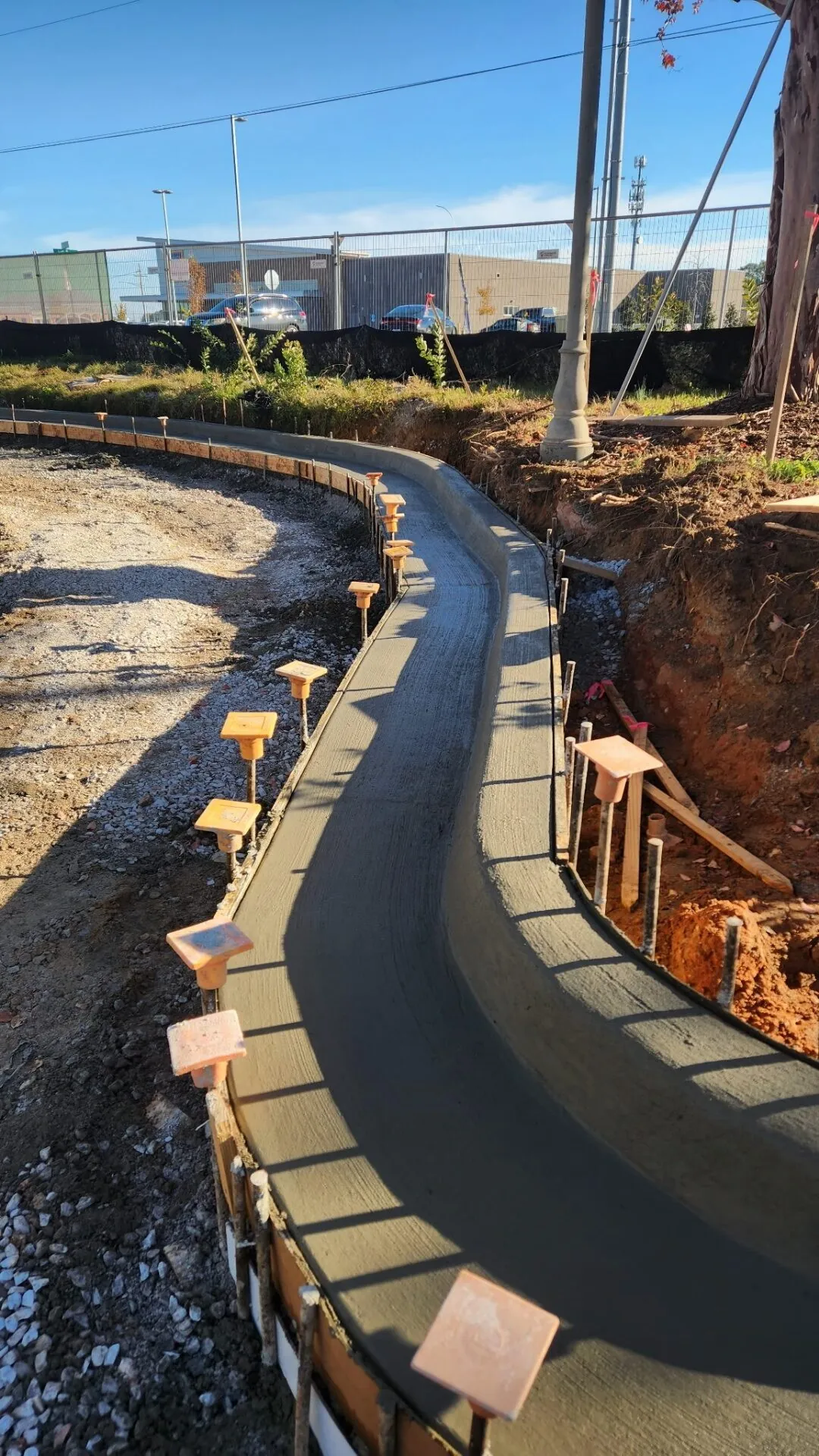 Curved concrete sidewalk poured into rebar-set forms at a North Alabama commercial property