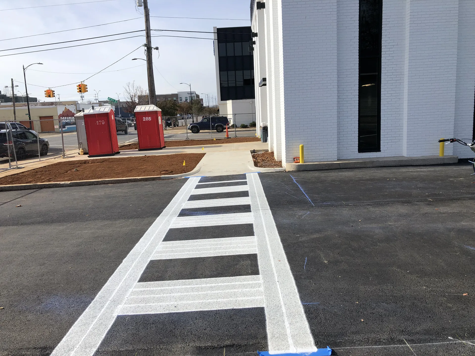 Freshly painted crosswalk striping at a downtown Decatur commercial property by Project One Contracting